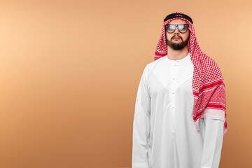 Wall Mural - A Saudi Arab man in national dress and sunglasses. Dishdasha, kandora, thobe, islam. Copy space.