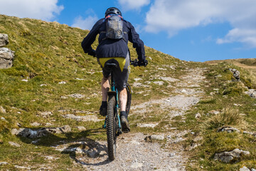 Mountain bike climbing hill near Yockenthwaite in the Yorkshire Dales