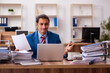 © Elnur - Young male employee working in the office