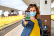 © Melinda Nagy - health Vaccine Passport for Coronavirus or Covid-19. Traveller Using Mobile Phone with Vaccination in Immune Status to Certificated International Traveling in train station