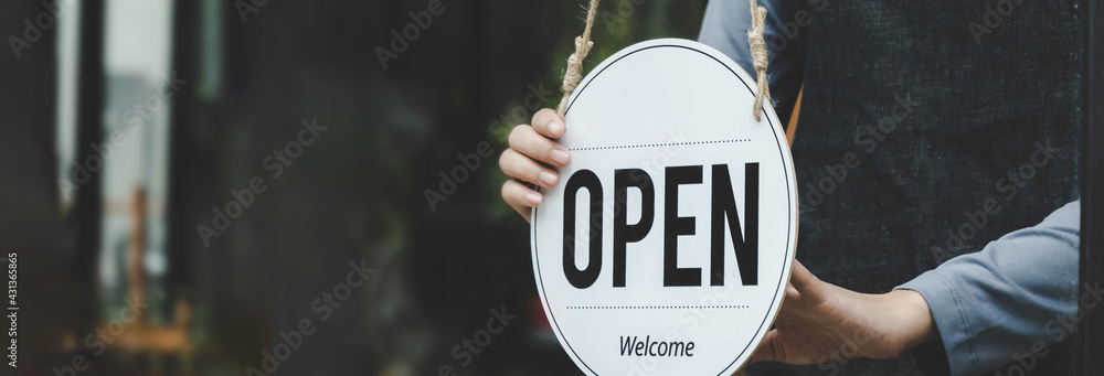 wide banner. Reopen. waitress hand turning open sign board on glass door in modern cafe coffee shop ready to service, cafe restaurant, retail store, small business owner, food and drink concept - obrazy, fototapety, plakaty 