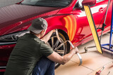 Fototapeta  - Removing dents on the car. PDR technology. Car body repair without painting.