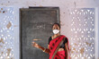 Indian female teacher in face mask at school during Covid-19 pandemic