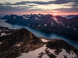 Poster - Frozen mountain landscape with a small lake against sunset sky background