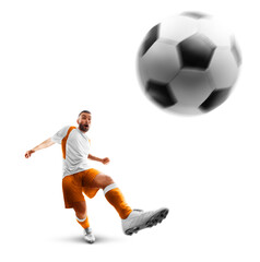 Power soccer kick. A soccer player kicks the ball. Professional soccer player in action. Isolated