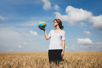 Sticker - Young Businesswomen in white keeping globe in hand at wheat field