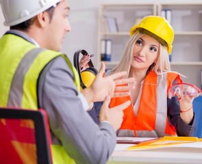 Construction workers having discussion in office before starting