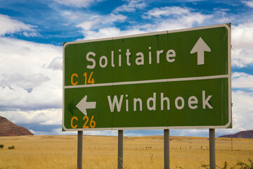 Windhoek and solitaire direction road signs in Namibia with cloudy sky. Namibia 2010