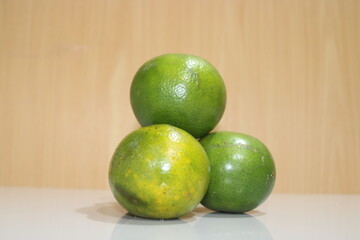 three green oranges ready to eat