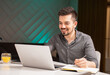 © areporter - The young bearded man writes in a diary while working from home.