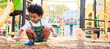 © chayantorn - Cute African American little kid boy funny while playing on the playground in the daytime in the spring season. Outdoor activity. Playing make-believe the concept. Outside education. Banner size