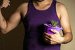 © Narayan - man holding a potted plant for decoration, houseplant concept