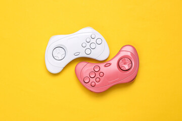 Wall Mural - Retro gamepads on yellow background. Creative gaming layout. Minimalism. Top view. Flat lay