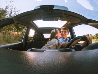 Wall Mural - young happy couple in car