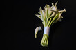 Wedding bouquet of white Calla lilies on a black background
