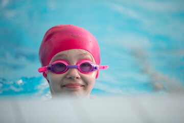 Child athlete swims in the pool. Swimming section.