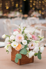 table centerpiece with white and peach rustic floral arrangement in wood box. Rustic wedding table.