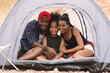 Happy family african american be loving child inside tent on camping hoilday at yellow grass field. Camping concept.