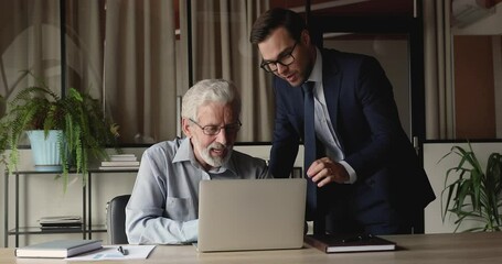 Poster - Happy different generations businessmen looking at laptop screen, discussing online sales or marketing research results, preparing electronic report analyzing data statistics together in office.