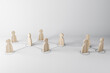 Social distance and communication concept with wooden figures located at a distance on light surface