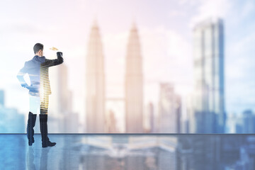 Wall Mural - Businessman standing and watching far away with a cityscape in the background, future success and promotion concept. Double exposure