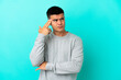 © luismolinero - Young handsome man over isolated blue background with problems making suicide gesture