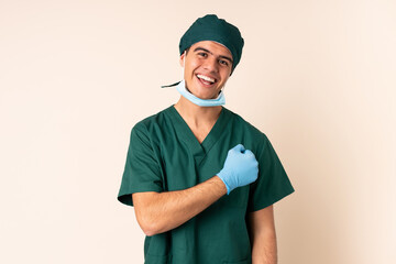 Wall Mural - Surgeon man in blue uniform over isolated background celebrating a victory