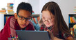 © TommyStockProject - Two preteen diverse students using laptop in classroom