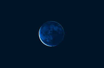big blue full moon close up on black sky