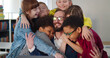 © TommyStockProject - Interracial kids hugging happy teacher at table in classroom