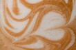 © fesenko - close-up of wonderful white milk patterns on brown foam of coffee drink.