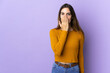 © luismolinero - Young caucasian woman over isolated background covering mouth with hand