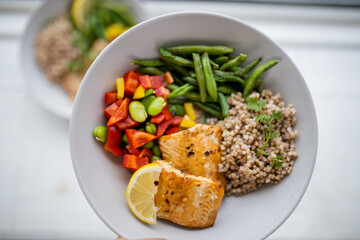 Salmon and buckwheat dish with green beans and tomato