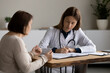 © fizkes - Young female doctor or therapist write prescription consult mature patient at meeting in clinic. Caucasian woman GP note complaints in medical journal at consultation with senior client in hospital.