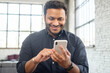 © Face Stock - Positive indian guy using smartphone for online communication, smiling mixed-race guy browsing, scrolling news feed, messaging in social media,hindu man holds phone and enjoying new mobile application