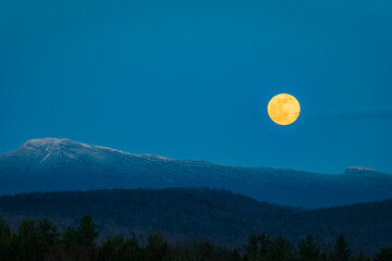 super moon rising over mount mansfield in the green mountains of vermont