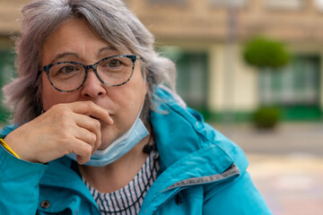 white haired woman drinking coffee at the bar