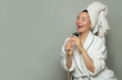 © artmim - Happy excited spa model woman taking a shower and singing on gray background