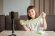 © Наталия Бражник - child girl 8 years old schoolgirl blogger making slime broadcasts via phone at home. High quality photo