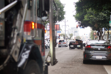 Naklejka na meble Trash truck approaching a dumpster.
