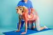 © alphaspirit - Girl performs exercises with a physiotherapist. Cyan background