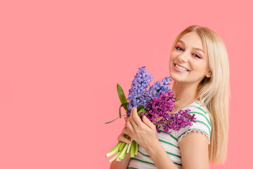 Wall Mural - Beautiful young woman with hyacinth flowers on color background