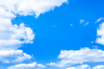 Wall Mural - soft fluffy clouds floating over bright blue sky on sunny day. beautiful pure white cloudscape scene
