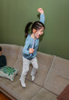 © David Pereiras - Little girl jumping and playing on the sofa