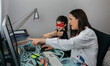 © David Pereiras - Woman teleworking with daughter talking to her. Selective focus on girl in background