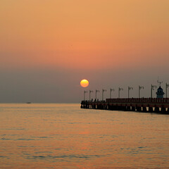 Wall Mural -  sunrise on the bridge jetty in the middle of the sea