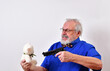 Mature man threatening to shoot a toy bear