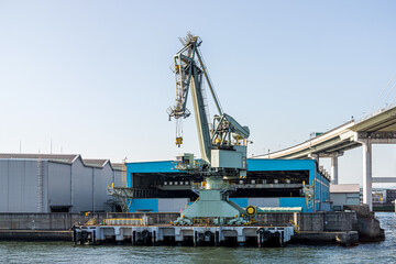 Crane and factory at seaside. This area is located at Osaka port in Japan.