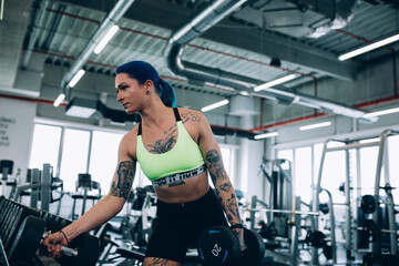 Wall Mural - tattooed woman workout in gym