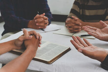 Christian Groups Sitting Within The Church. Studying The Word Of God In Churches. Devotional Or Prayer Meeting Concept. Group Of Interlocked Fingers Praying Together